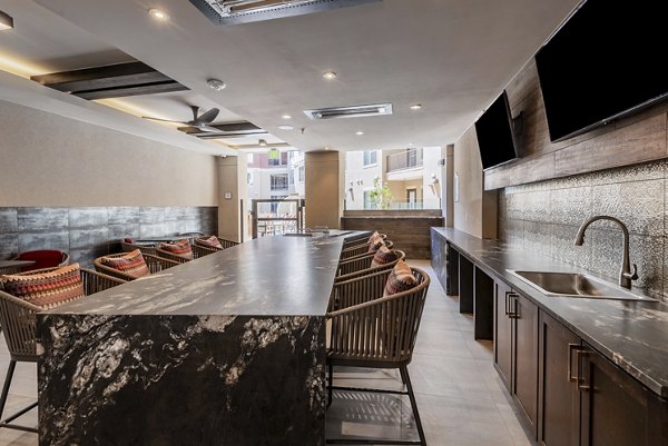 Dining area featuring elegant lighting and modern decor in Luxe at Mile High apartments