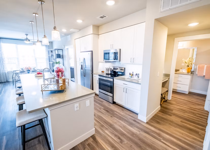 Dining area featuring modern furnishings and elegant lighting in Luxe at Mile High luxury apartments
