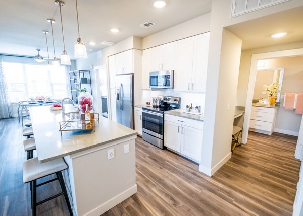 Dining area featuring modern furnishings and elegant lighting in Luxe at Mile High luxury apartments