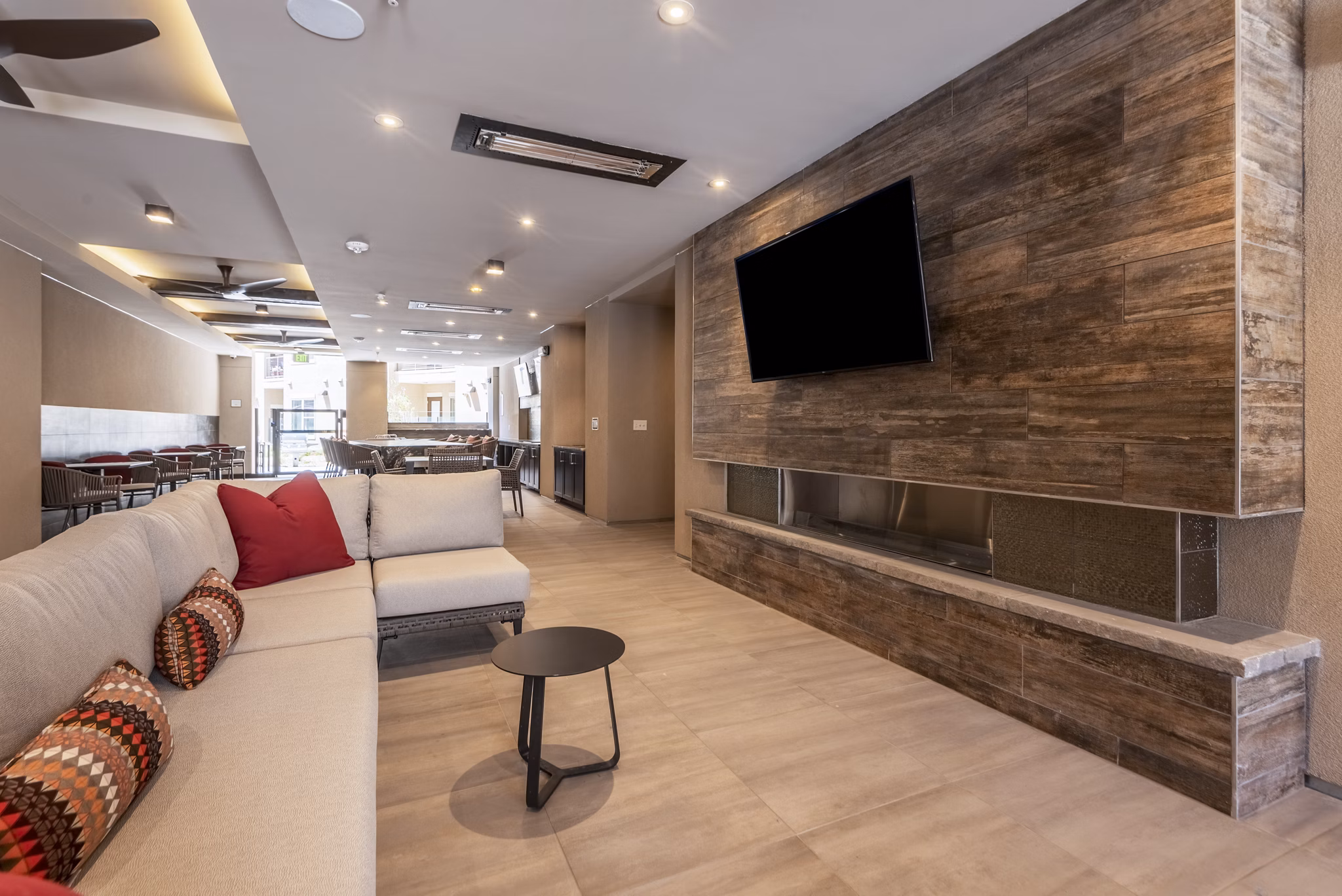 Living room featuring chic furniture and expansive windows at Luxe at Mile High luxury apartments