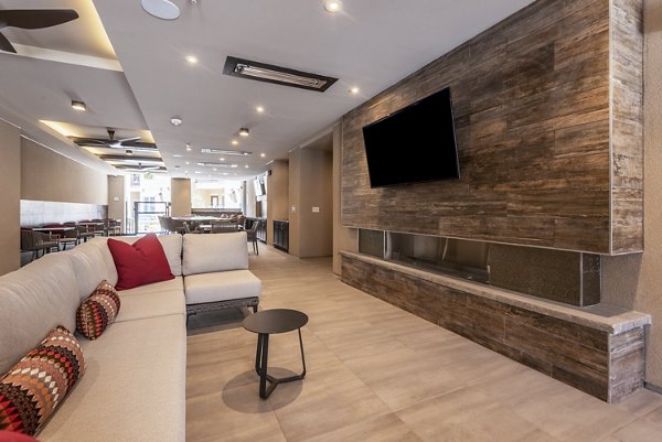 Living room featuring chic furniture and expansive windows at Luxe at Mile High luxury apartments