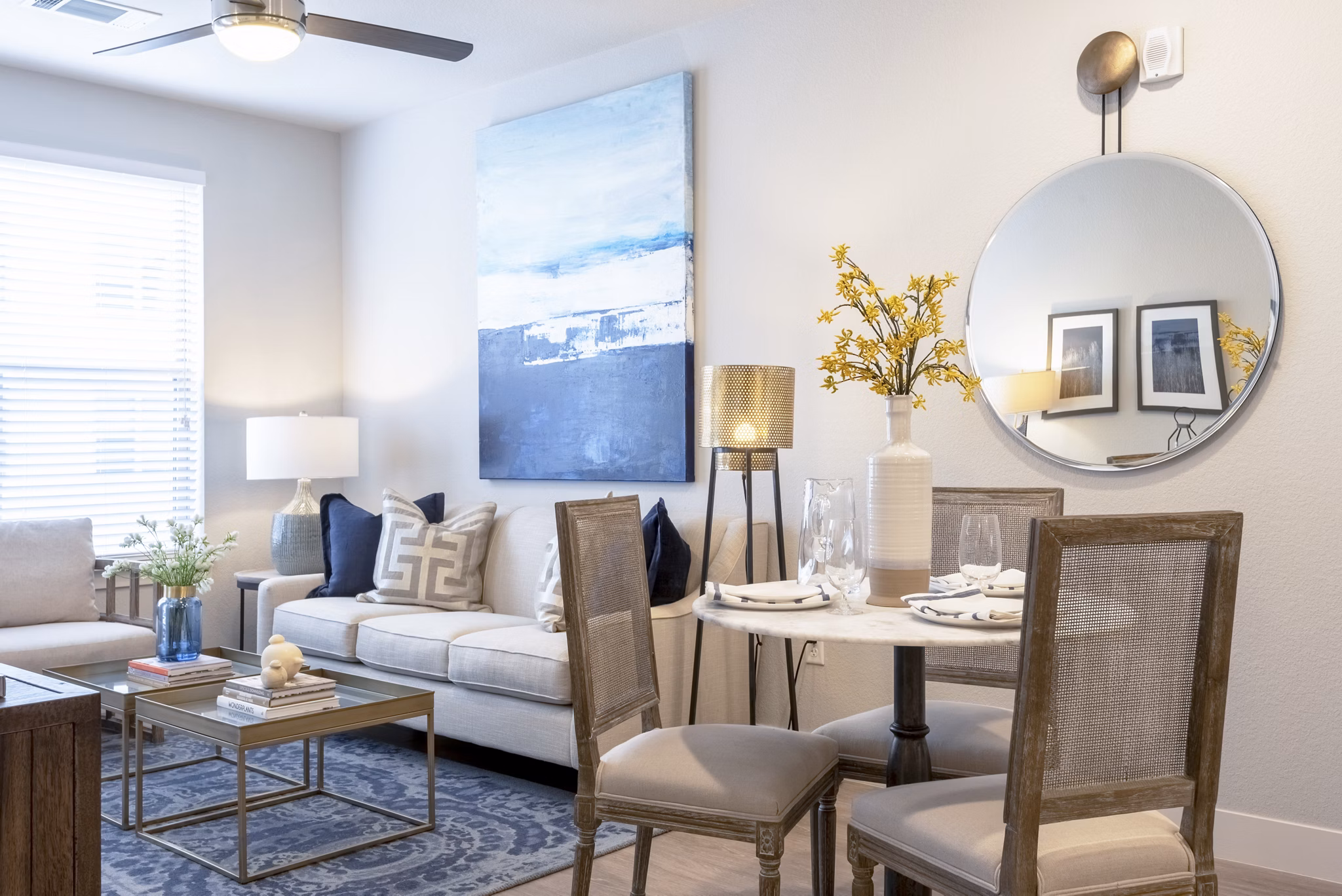 Spacious living room featuring stylish furniture and large windows in Luxe at Mile High apartments