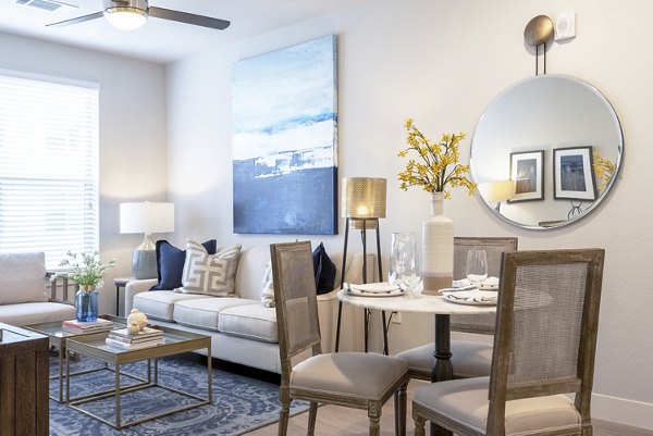 Spacious living room featuring stylish furniture and large windows in Luxe at Mile High apartments