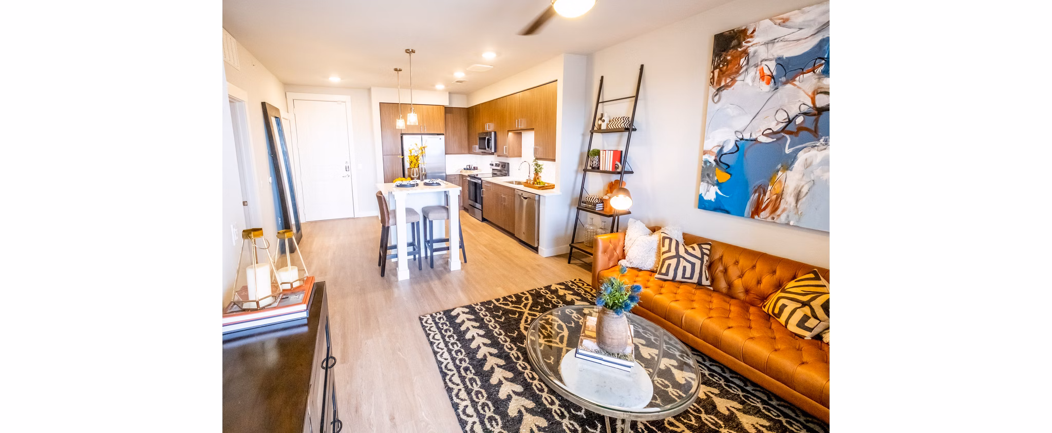 Stylish living room with modern furnishings and large windows in Luxe at Mile High luxury apartments