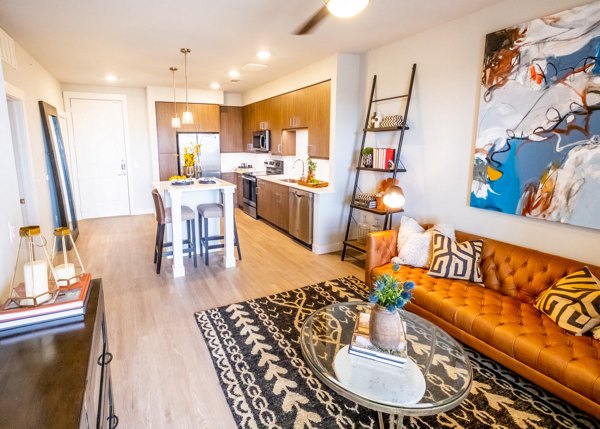 Stylish living room with modern furnishings and large windows in Luxe at Mile High luxury apartments