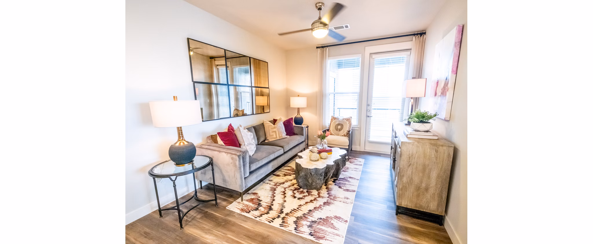 Spacious living room with modern decor and city views at Luxe at Mile High luxury apartments