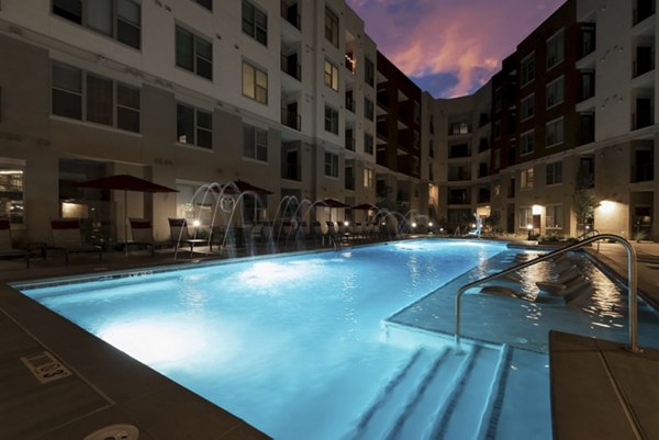 Luxe at Mile High: Modern pool area with lounge seating and city views