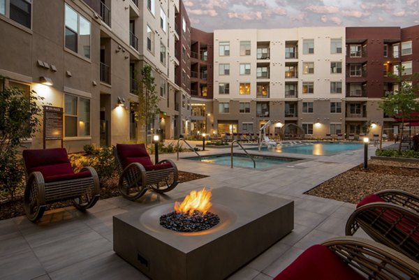 Resort-style pool surrounded by lush landscaping at Luxe at Mile High luxury apartments