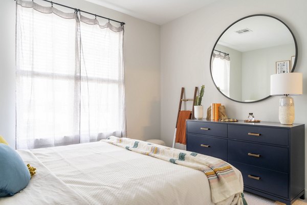 The Madison at Marshfield: Cozy bedroom with elegant decor and natural lighting