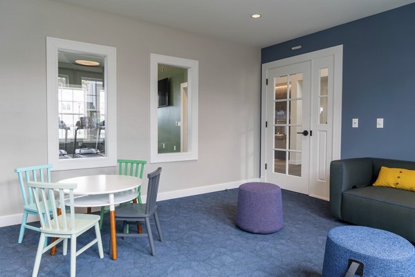 Clubhouse featuring elegant seating and modern design at The Madison at Marshfield apartments in luxury Greystar community