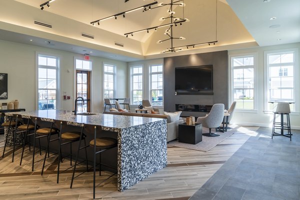 Clubhouse with modern seating and large windows at The Madison at Marshfield luxury apartments