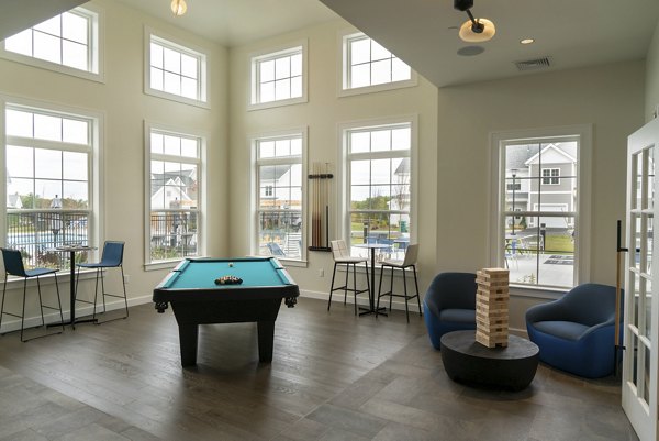 Elegant clubhouse with cozy seating and modern decor at The Madison at Marshfield apartments