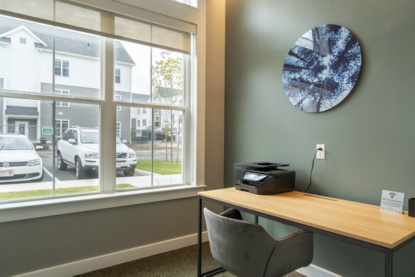 Clubhouse featuring modern design and cozy seating at The Madison at Marshfield apartments