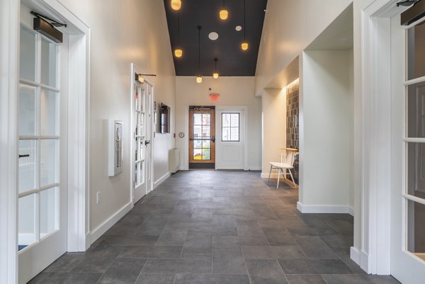 Clubhouse with modern decor and sitting areas at The Madison at Marshfield apartments