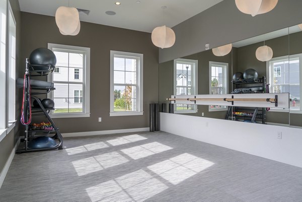 State-of-the-art fitness center with modern equipment at The Madison at Marshfield apartments