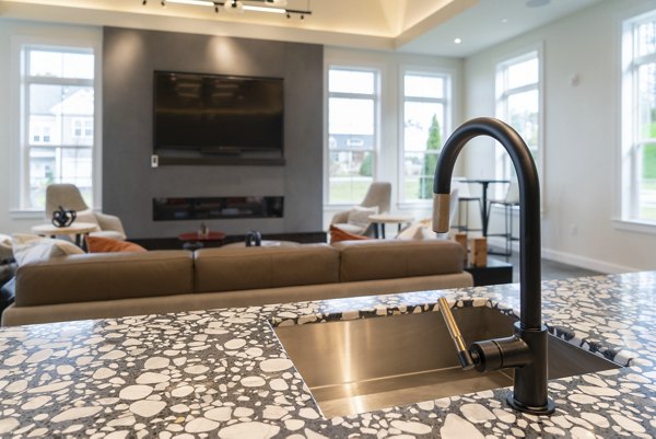 Modern kitchen with stainless steel appliances and granite countertops in The Madison at Marshfield apartments