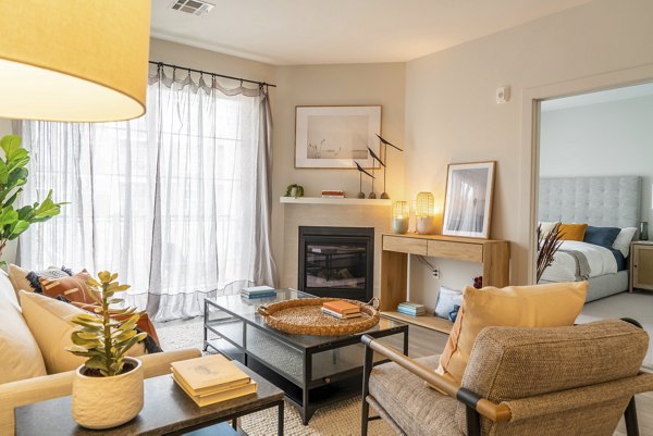 Living room featuring elegant decor and a cozy seating area in The Madison at Marshfield apartments