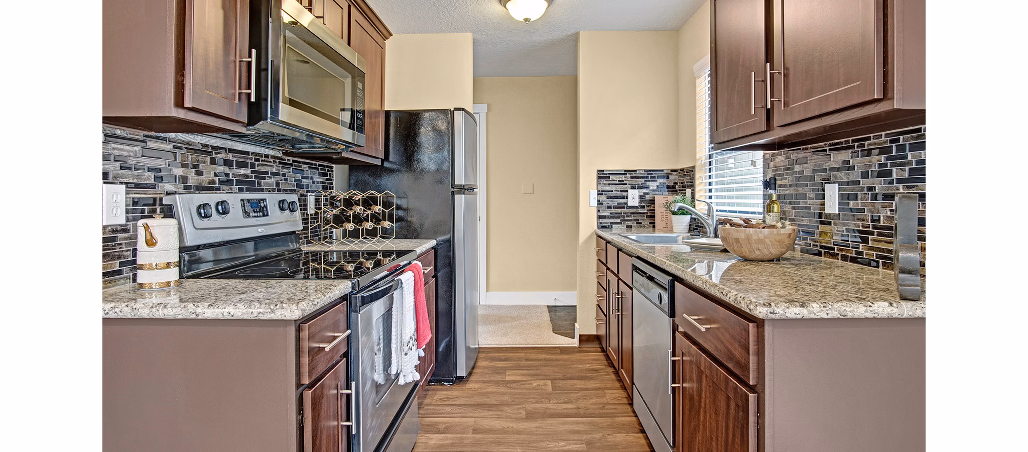 Modern kitchen with stainless steel appliances at One Jefferson Apartments