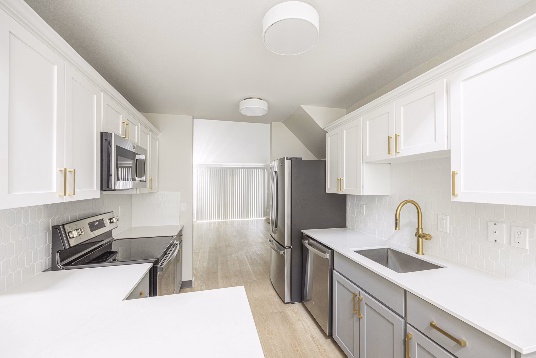 Modern kitchen with stainless steel appliances in One Jefferson Apartments