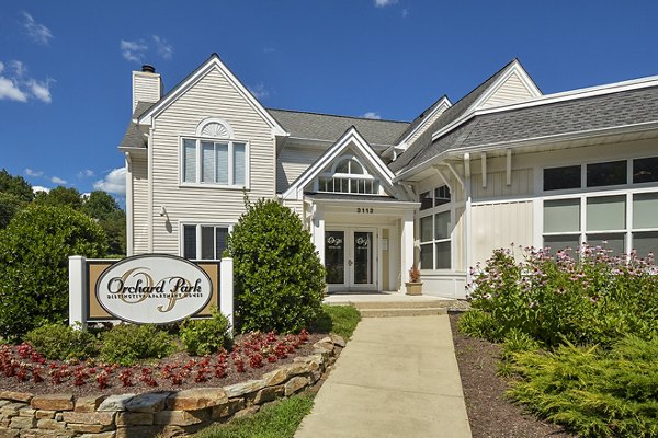 Orchard Park Apartments: Elegant building surrounded by lush greenery in a suburban setting
