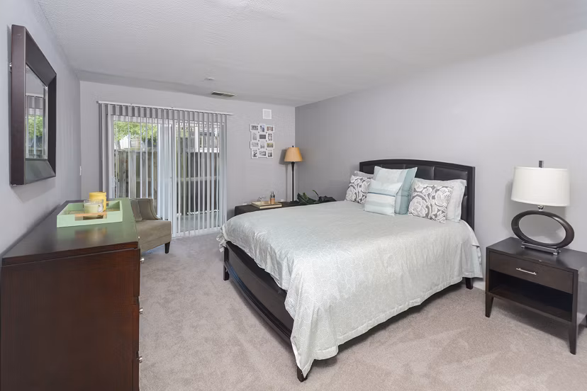 Cozy bedroom with neutral tones and modern decor in Orchard Park Apartments
