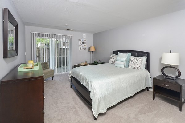 Cozy bedroom with neutral tones and modern decor in Orchard Park Apartments