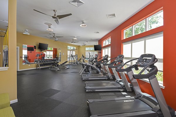 Well-equipped fitness center at Orchard Park Apartments with modern exercise machines and free weights, promoting active lifestyle and wellness