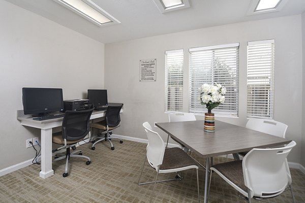 Spacious living room with contemporary decor at Orchard Park Apartments in a Greystar community