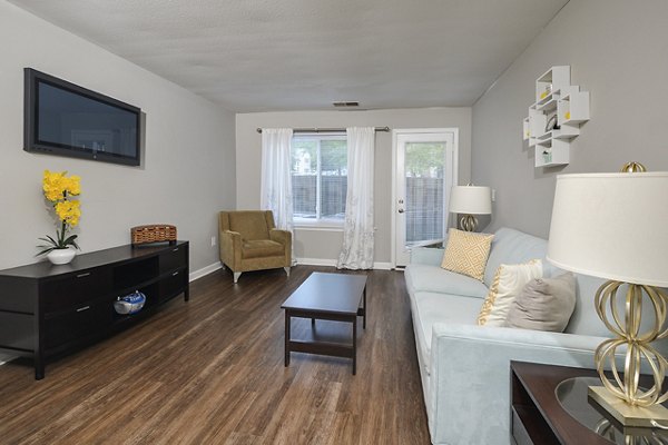 Cozy living room with modern furnishings at Orchard Park Apartments featuring stylish decor and ample natural light