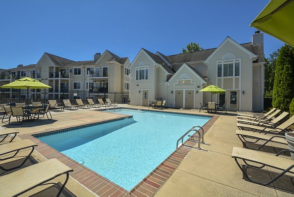 Orchard Park Apartments: Resort-style pool with sun loungers and landscaped gardens