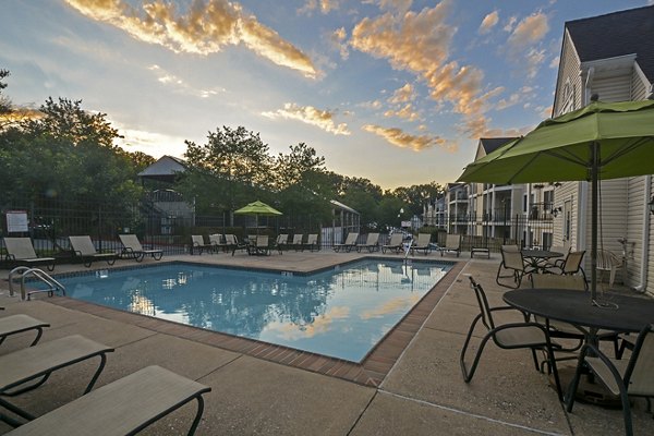 Relaxing pool area with sun loungers at Orchard Park Apartments