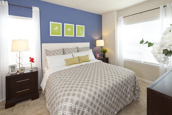 Stylish bedroom with modern furnishings at The Park at Walnut Ridge Apartments