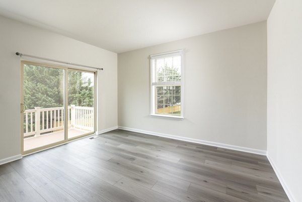 Cozy living room with modern decor at Towns at Walnut Ridge Apartments, featuring plush seating and natural light for elegant living