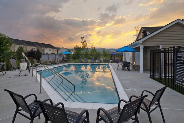 Resort-style pool with lounge chairs at The Park at Walnut Ridge Apartments, offering a relaxing retreat for residents