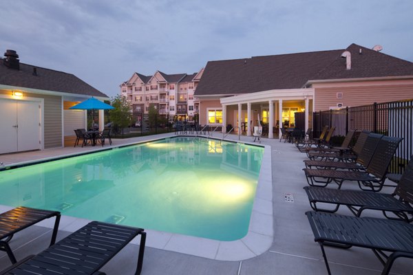 Resort-style pool with lounge chairs at The Park at Walnut Ridge Apartments