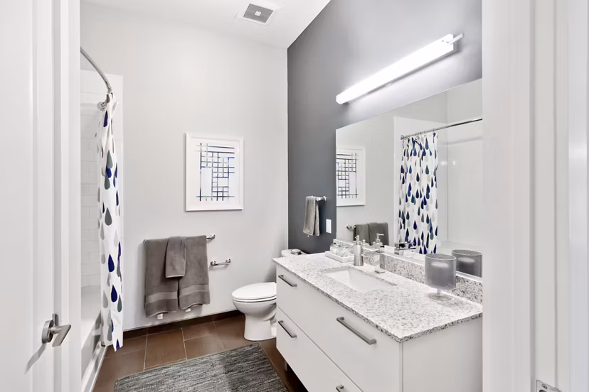 Bathroom featuring sleek fixtures and modern design at Re150 Apartments