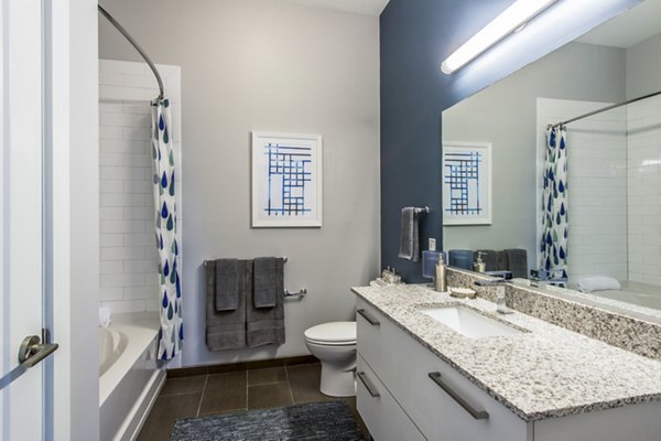 Bathroom featuring sleek fixtures and modern design at Re150 Apartments