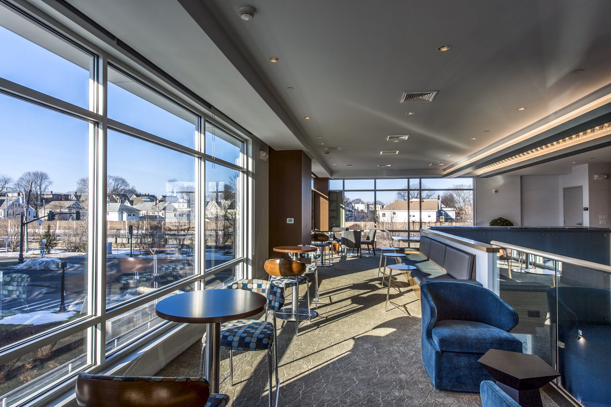 Modern clubhouse with cozy seating and large TV at Re150 Apartments