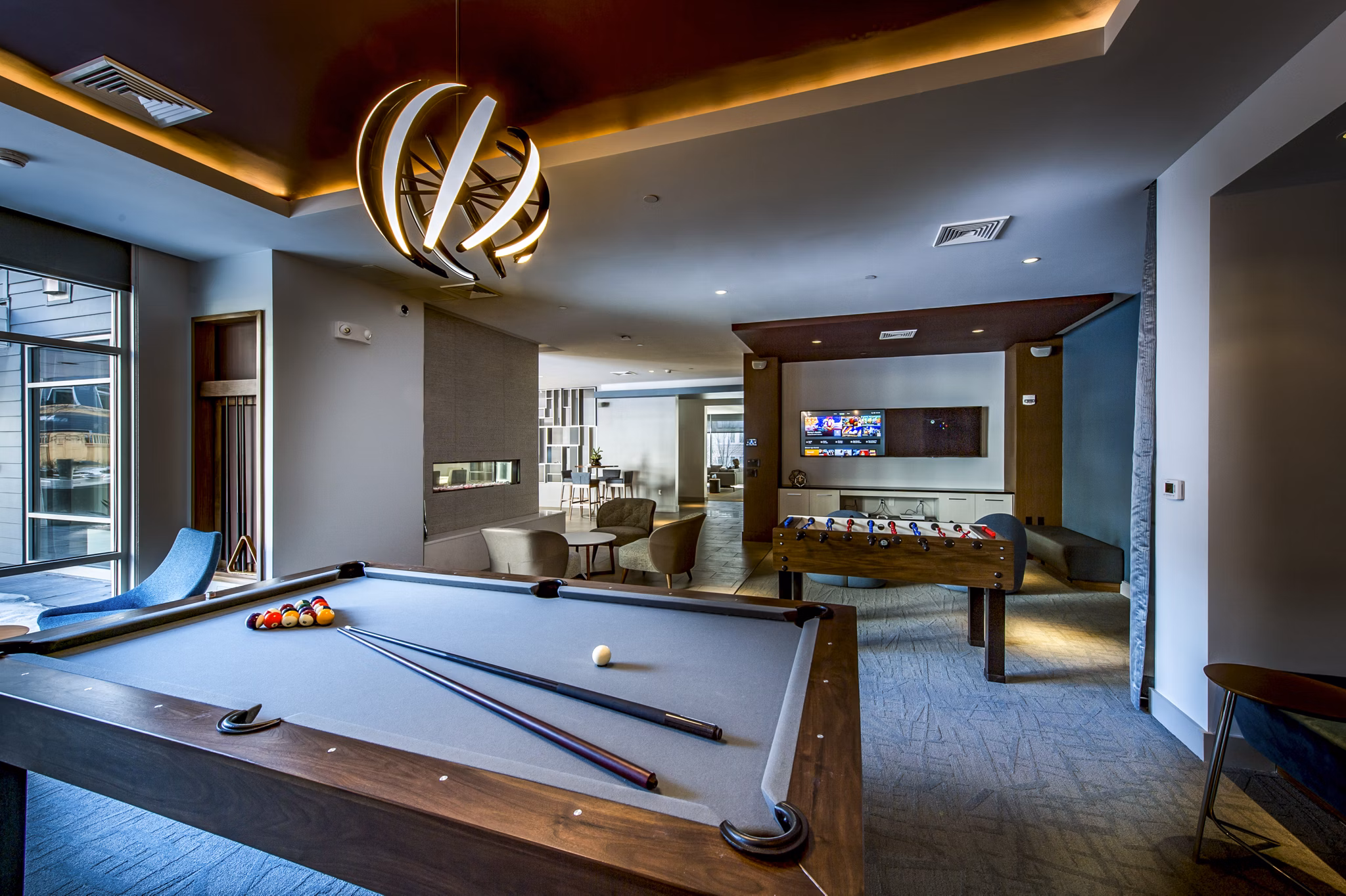 Game room with pool table and modern decor at Re150 Apartments
