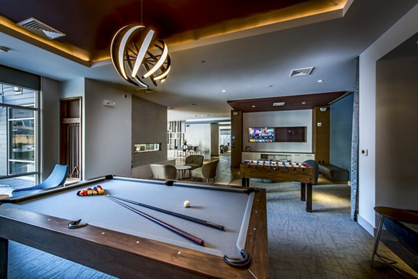 Game room with pool table and modern decor at Re150 Apartments