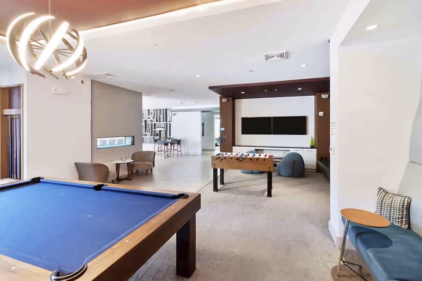 Modern clubhouse with elegant furnishings at Re150 Apartments, perfect for social gatherings and relaxation