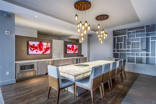 Modern clubhouse with elegant furnishings at Re150 Apartments, perfect for social gatherings and relaxation
