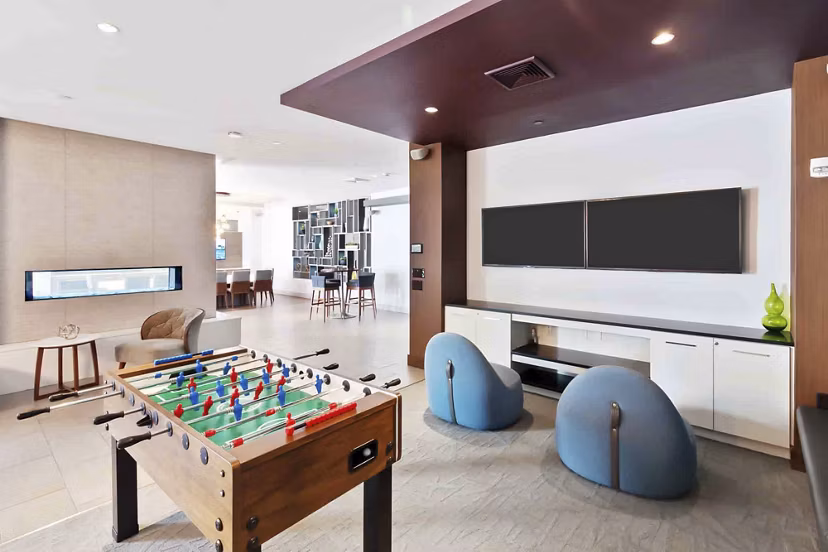Modern clubhouse featuring social lounge and entertainment areas at Re150 Apartments, a Greystar luxury property