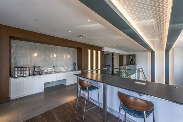 Modern clubhouse featuring social lounge and entertainment areas at Re150 Apartments, a Greystar luxury property