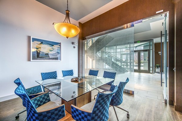 Clubhouse meeting facility featuring modern design and seating at Re150 Apartments, ideal for gatherings and events