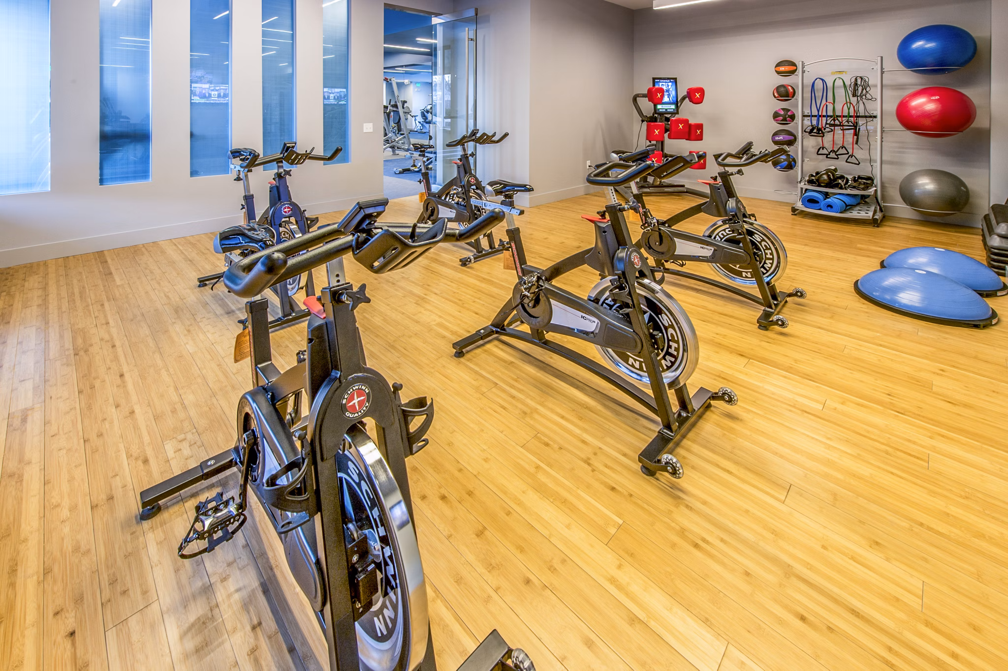 Yoga/spin studio with modern equipment at Re150 Apartments: Luxury fitness facilities for residents