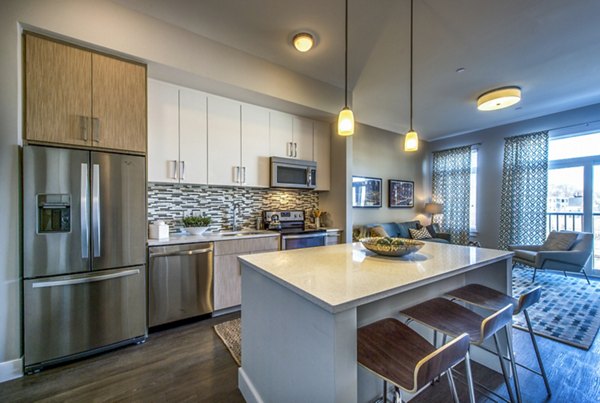 Modern kitchen with stainless steel appliances at Re150 Apartments, a luxury property by Greystar in the heart of Medford