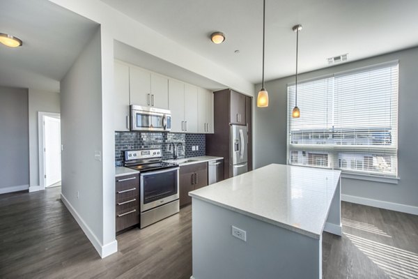 Modern kitchen with stainless steel appliances at Re150 Apartments, a luxury community in the heart of Greystar's offerings
