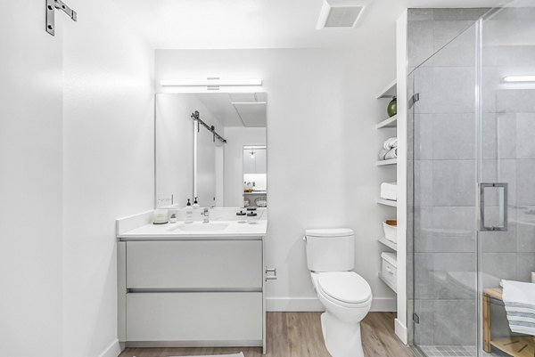 Bathroom with modern fixtures at Rinrose Apartments, luxury living by Greystar