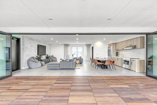 Spacious living room featuring modern decor and natural light at Rinrose Apartments luxury rental units